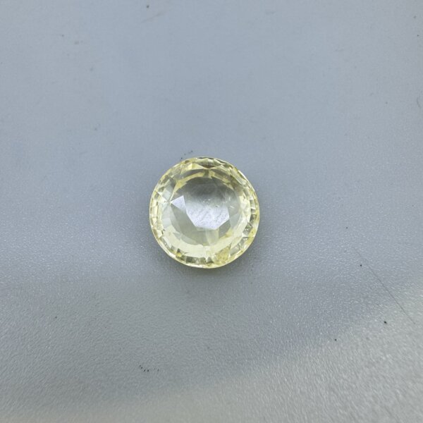 9.68 carat natural yellow sapphire pukhraj gemstone 10.67 ratti – certified Ceylon origin untreated yellow stone on white background.