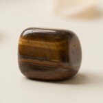 Natural tiger eye tumble stone polished brown crystal shown in front side top and angled views