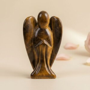 Tiger Eye Angel Figurine held in hand with cream background and soft flower petals