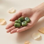 Natural green jade tumble stone polished green crystal shown in front side top and angled views