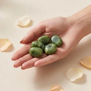 Natural green jade tumble stone polished green crystal shown in front side top and angled views