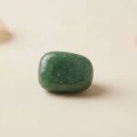 Natural green aventurine tumble stone polished green crystal shown in front side top and angled views