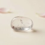 Natural clear quartz tumble stone transparent polished crystal shown in front side top and angled views