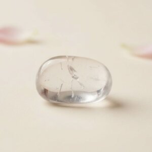 Natural clear quartz tumble stone transparent polished crystal shown in front side top and angled views