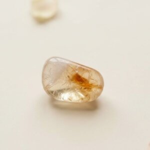 Natural citrine tumble stone polished yellow crystal shown in front side top and angled views