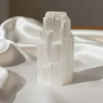 Selenite Crystal featuring a natural white translucent stone with a smooth, luminous appearance.