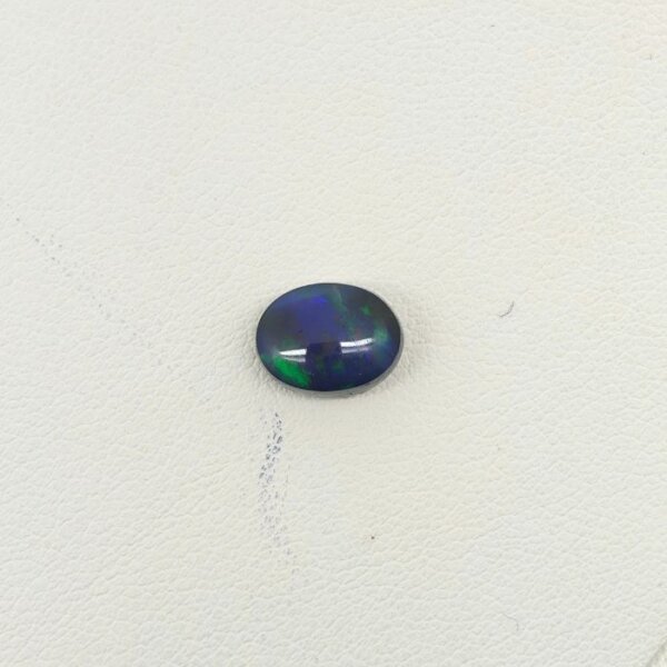 Natural Black Opal gemstone featuring mesmerizing multicolor flashes, deep dark body tone, and exceptional natural brilliance.
