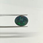 A stunning Natural Black Opal gemstone showcasing mesmerizing flashes of blue, green, red, orange, and purple against a rich dark background. Admired for its exceptional rarity, captivating play-of-color, astrological significance, and luxurious appeal for fine jewellery, collectors, and gemstone enthusiasts.