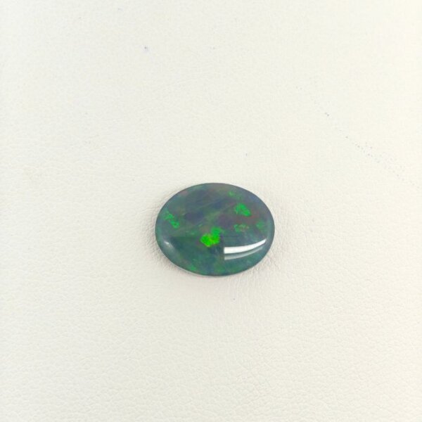 Natural Black Opal gemstone featuring vivid multicolor play-of-color, deep dark body tone, and exceptional natural brilliance.