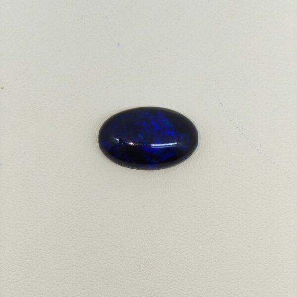 Natural Black Opal gemstone featuring brilliant multicolor flashes, deep dark body tone, and exceptional natural brilliance.