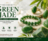Luxury Green Jade gemstone jewelry display featuring a jade ring, pendant, bracelet, Buddha carving, and natural jade stone on a cream and maroon themed background.