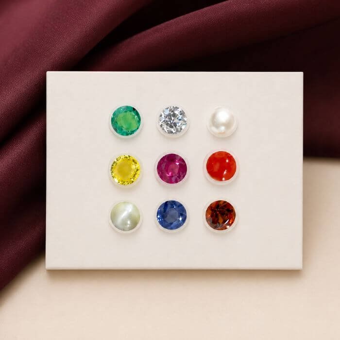 Loose Navratna gemstone collection featuring nine vibrant natural gemstones arranged together with radiant colors and polished brilliance.