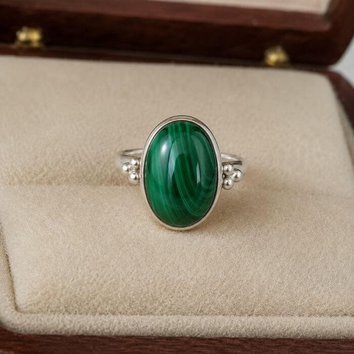 Malachite Rings featuring vibrant green malachite gemstones with unique natural banding set in elegant ring designs.
