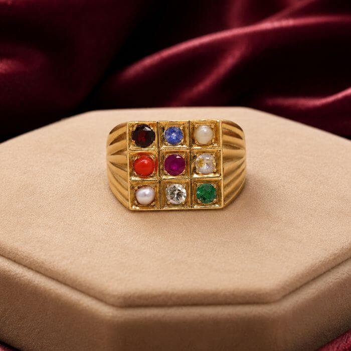 Navratna Ring featuring nine vibrant natural gemstones arranged in a traditional ring design with radiant multicolored brilliance.