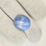 Premium Natural Star Blue Sapphire gemstone featuring a captivating star effect (asterism), rich blue color, oval cabochon cut, and authenticity certification. Ideal for jewelry, collections, and astrology purposes.