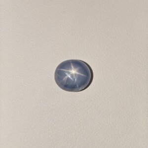 Star Blue Sapphire gemstone featuring a deep blue hue with a natural star-like asterism effect and radiant polished finish.