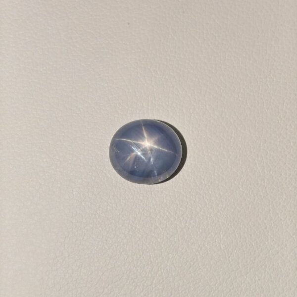 Star Blue Sapphire gemstone featuring a deep blue hue with a natural star-like asterism effect and radiant polished finish.