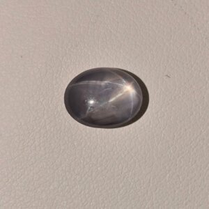 Star Blue Sapphire ST-010 featuring a deep blue natural gemstone with a prominent star-like asterism effect and polished radiant finish.