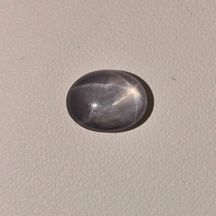 Star Blue Sapphire ST-010 featuring a deep blue natural gemstone with a prominent star-like asterism effect and polished radiant finish.