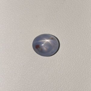 Star Blue Sapphire ST-012 featuring a rich deep blue natural gemstone with a striking star-like asterism effect and polished radiant finish.