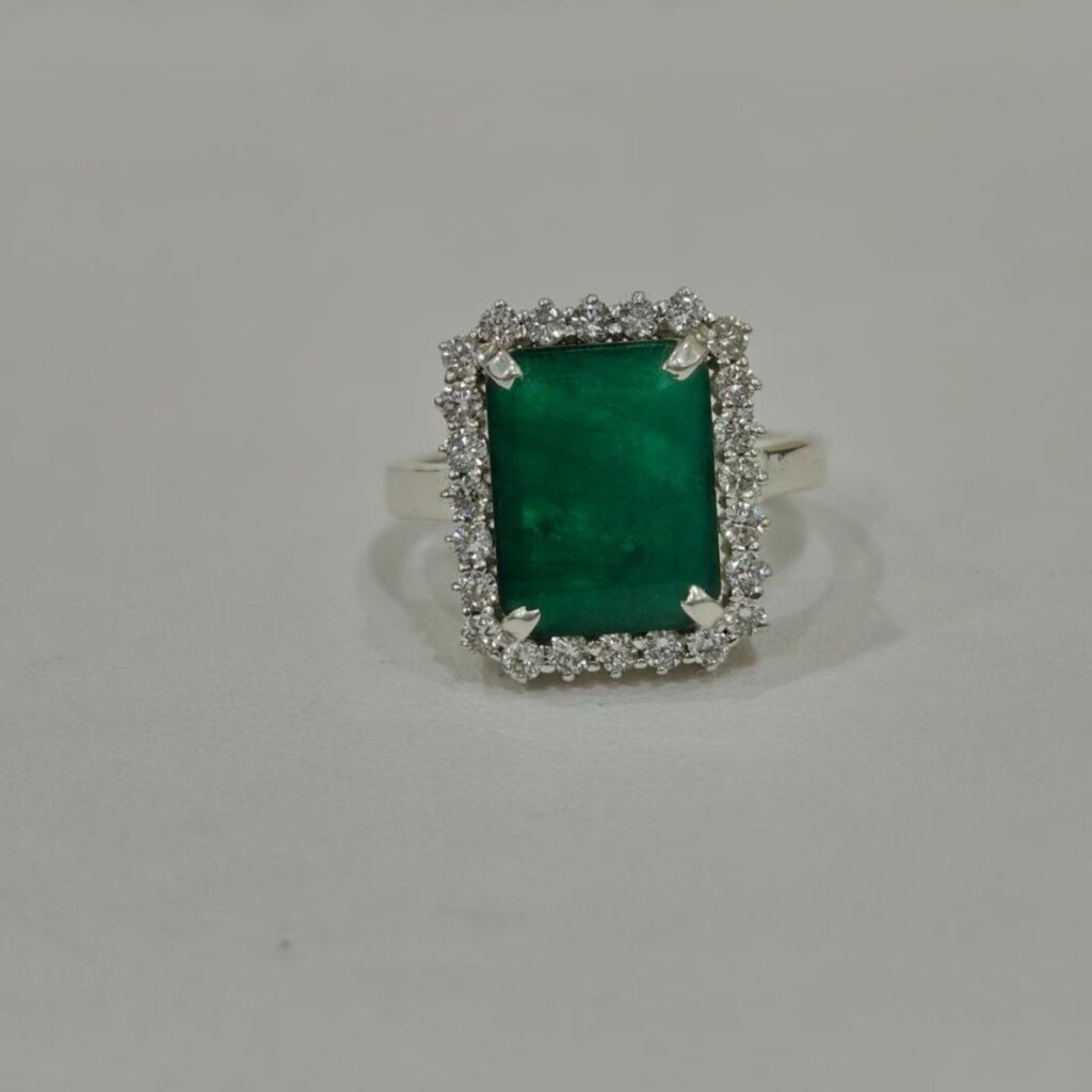 Emerald halo silver ring side angle with rectangular green gemstone