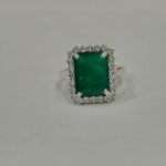 Emerald halo silver ring side angle with rectangular green gemstone