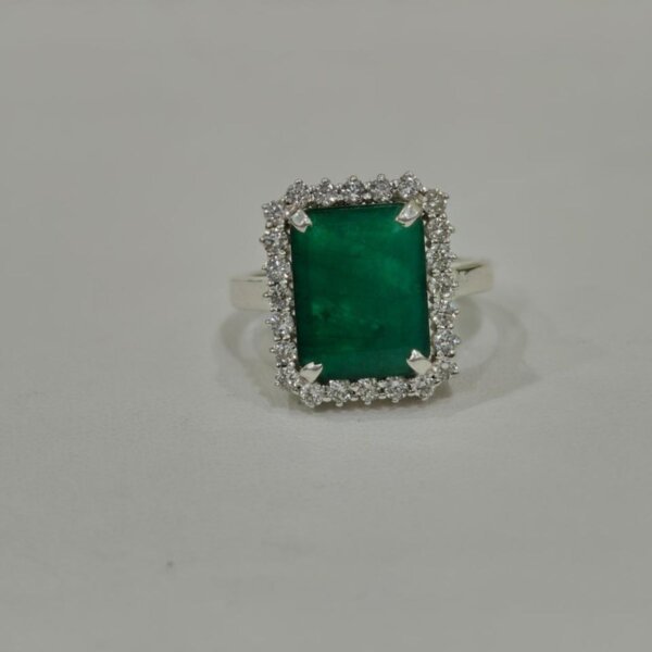 Emerald halo silver ring side angle with rectangular green gemstone