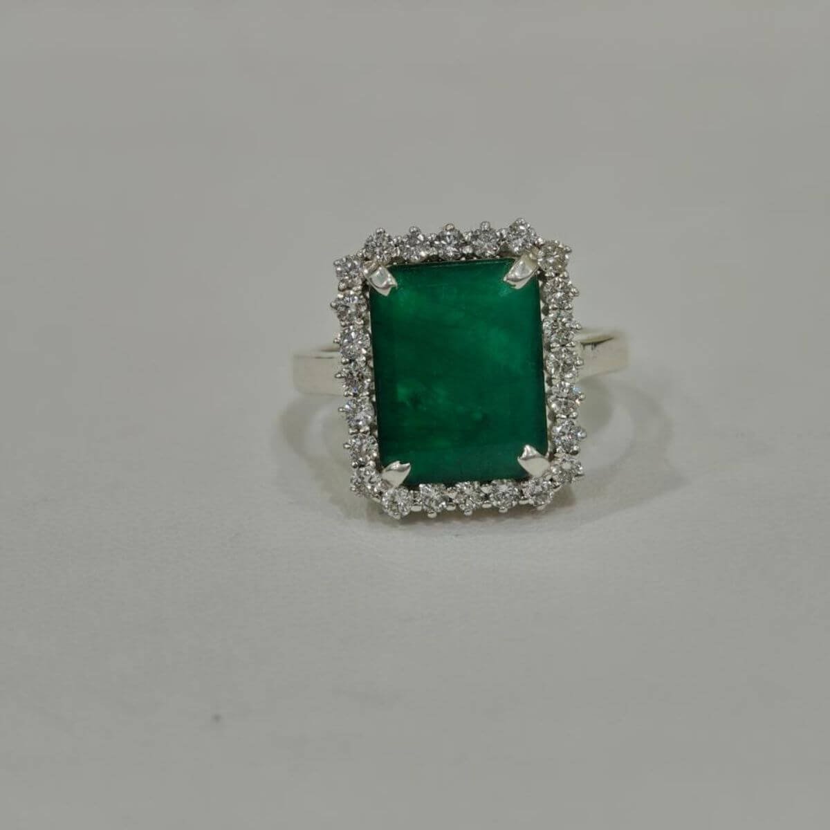 Royal Emerald Halo Silver Ring – Side Angle Emerald halo silver ring side angle with rectangular green gemstone