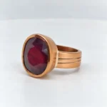 Vintage Oval Ruby Bezel Ring with faceted ruby gemstone in classic warm-tone metal setting
