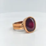 Side angle view of Vintage Oval Ruby Bezel Ring with oval ruby and grooved band design
